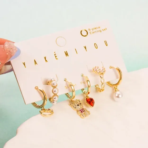 Set de aretes plata 925 con baño de oro diseño de oso lazo y corazón