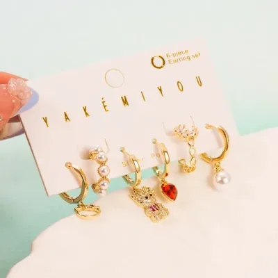 Set de aretes plata 925 con baño de oro diseño de oso lazo y corazón