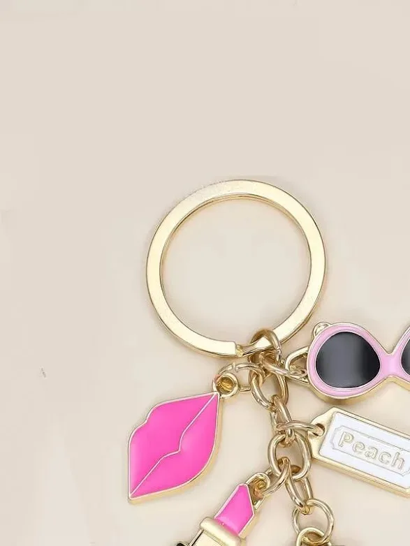 LLavero diseño de labios, lentes, cartera y labial
