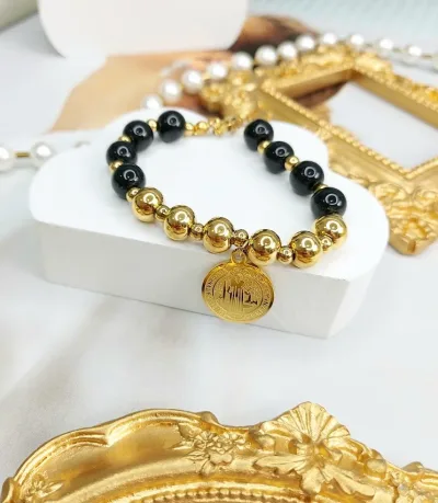 Pulsera de acero dorado con negro